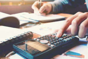 man doing forms and using a calculator