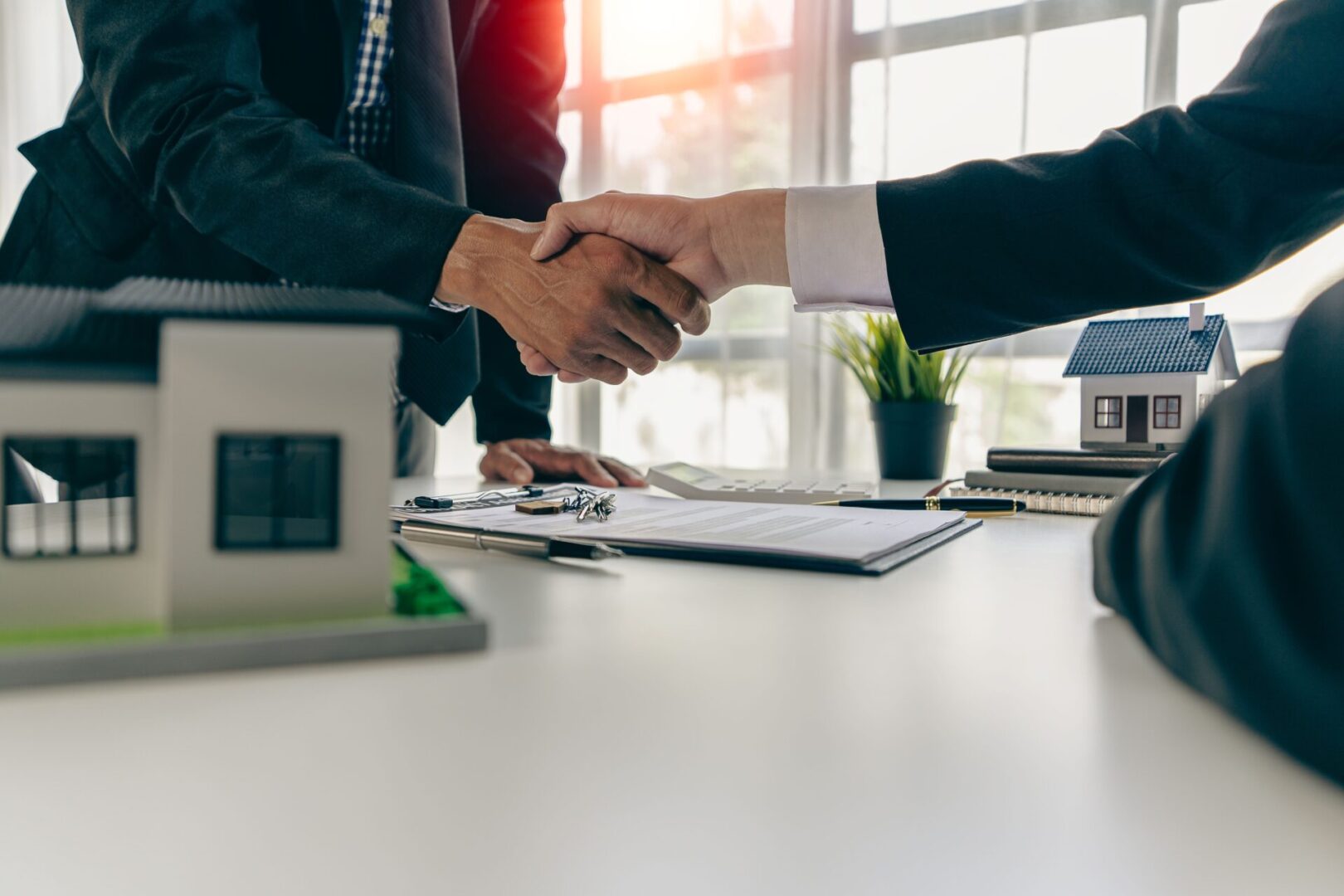 people shaking hands after making a deal